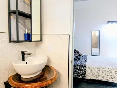 a bathroom with a sink and a bed at Italiana Hogares in Boca Chica