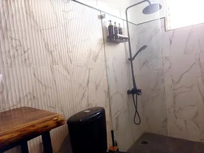 a bathroom with a shower with a shower head at Italiana Hogares in Boca Chica