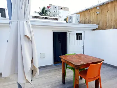 a wooden table and two chairs in a room at Italiana Hogares in Boca Chica
