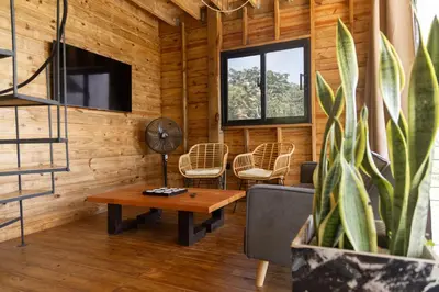 a living room with a table and chairs and a tv at Casa Loma, Descansar en la Montaña, 30min STG in La Búcara