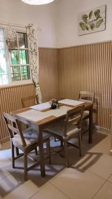 a wooden table and chairs in a room at Unique and quiet TROPICKÝ PRÁZDNINOVÝ DŮM in Punta Cana