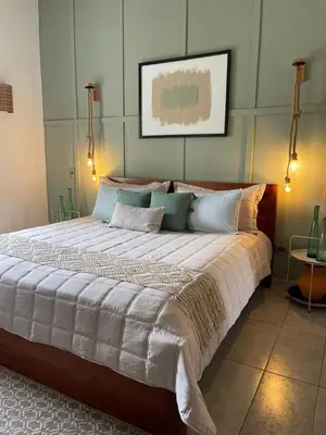 a large bed with white sheets and pillows at Sole E Mare Beach House in Las Terrenas