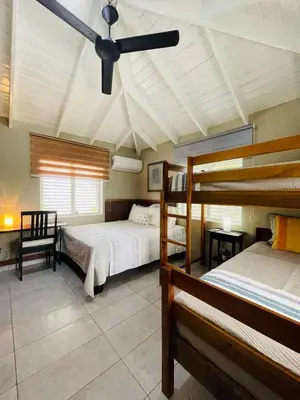 a bedroom with two bunk beds and a ceiling fan at Sole E Mare Beach House in Las Terrenas