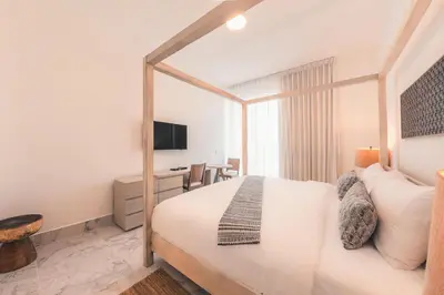 a hotel room with a bed and a desk at Penthouse with jacuzzi in Lake View in Las Terrenas