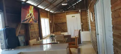 a room with a table and a painting on the wall at La casa de jasinta in San Felipe de Puerto Plata