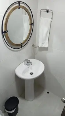 a bathroom with a white sink and a mirror at Urban oasis,3 beds, Elevator, Near the airport in Juan López