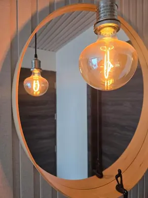 a mirror with two lights and a light fixture at Urban oasis,3 beds, Elevator, Near the airport in Juan López