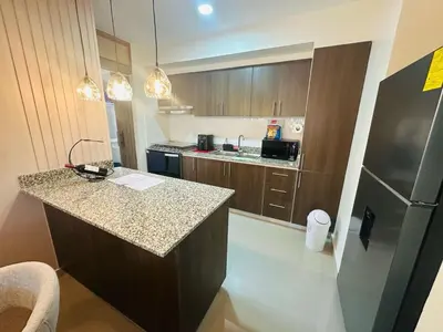 a kitchen with a counter and a refrigerator at Urban oasis,3 beds, Elevator, Near the airport in Juan López