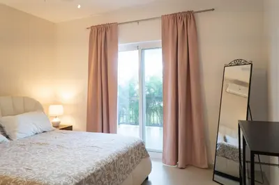 a bedroom with a bed and a large window at Residencial Esprit Caribbean in Bayahibe