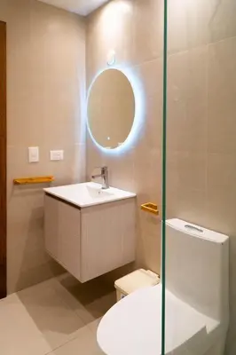 a bathroom with a sink and a toilet and a mirror at Residencial Esprit Caribbean in Bayahibe