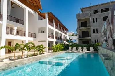 a swimming pool in front of a building at Residencial Esprit Caribbean in Bayahibe