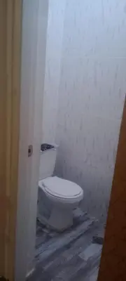 a bathroom with a white toilet in a room at Home away from home in Guayacanes