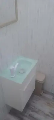 a white bathroom with a sink and a toilet at Home away from home in Guayacanes