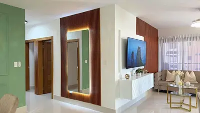 a living room with a couch and a mirror at Luxury Apartment-PRIVATE Patio & BBQ-Near Airport in Santiago de los Caballeros