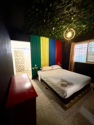 a bedroom with a bed with a colorful ceiling at Bed-Breakfast lunch Tropical Private-room in Santa Bárbara de Samaná