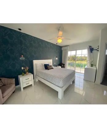 a bedroom with a bed and a green wall at Hotel Down Town Cabrera in Cabrera