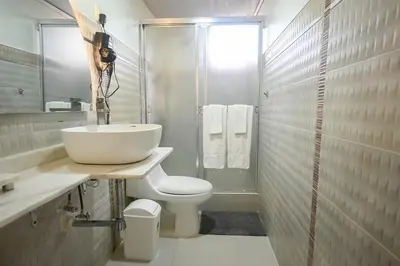 a white bathroom with a sink and a toilet at Estudio 2 Conde 504 at Historic Main Street in Santo Domingo