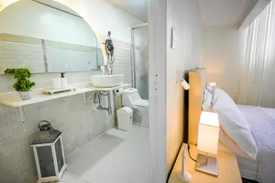 a bathroom with a sink and a mirror at Estudio 2 Conde 504 at Historic Main Street in Santo Domingo