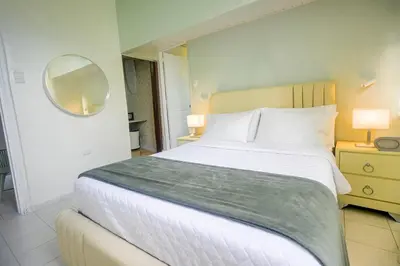 a bedroom with a large bed and a mirror at Estudio 2 Conde 504 at Historic Main Street in Santo Domingo
