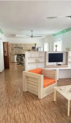 a living room with a couch and a tv at Villa Langosta in Las Terrenas