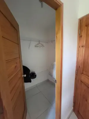 an open door to a room with a closet at Palma Real Apt Near Cibao Airport & Pool in Santiago de los Caballeros