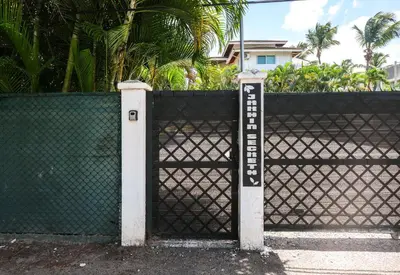 a black fence with a gate with a sign on it at Casa Zelima, a fully equipped apartment in Las Terrenas