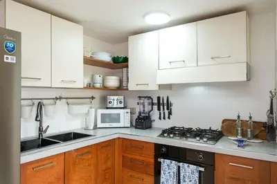 a kitchen with white cabinets and a stove top oven at Casa Zelima, a fully equipped apartment in Las Terrenas