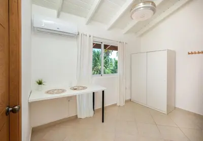 a white bathroom with two sinks and a window at Casa Zelima, a fully equipped apartment in Las Terrenas