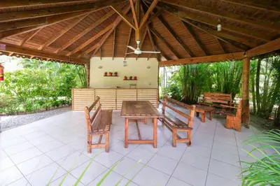 a patio with a wooden table and chairs on it at Casa Zelima, a fully equipped apartment in Las Terrenas