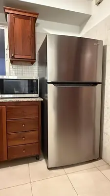 a stainless steel refrigerator in a kitchen at Cozy and Beautiful, 3 Bedroom Apartment Home in Santo Domingo