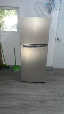 a stainless steel refrigerator in a kitchen with a window at Bargain Beach Getaway in Las Terrenas