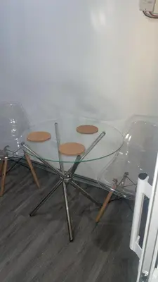 a glass table with four chairs on the floor at Bargain Beach Getaway in Las Terrenas