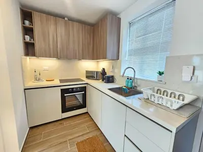 a kitchen with white cabinets and a sink and a window at Cana Cove in Punta Cana