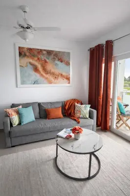 a living room with a couch and a table at Laguna del Sol in Sosúa