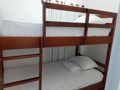 a couple of bunk beds with white pillows on them at Villas Reynoso, Near La Playita Beach in Las Galeras Samaná in Las Galeras