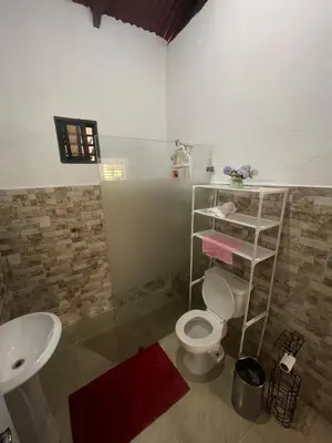 a bathroom with a toilet and a sink at Rancho La Loma in Higuey