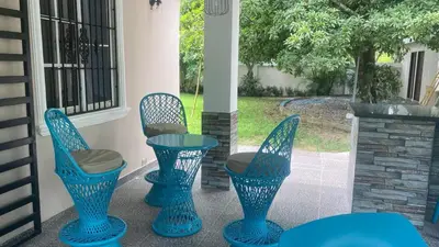four blue chairs and a table on a porch at Farm Escape in Colorado