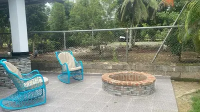 two blue chairs and a fire pit on a patio at Farm Escape in Colorado