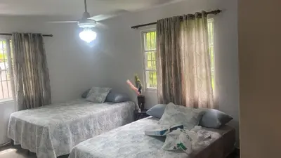 a bedroom with two beds and a couch and windows at Farm Escape in Colorado