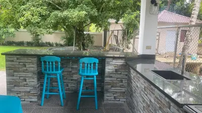 two blue stools sitting at a bar with a tree at Farm Escape in Colorado