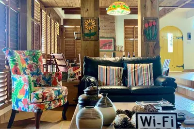 a living room with a couch and a chair at Villa del Pino en Quintas del Bosque in Jarabacoa
