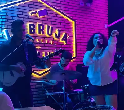 a group of people singing and playing instruments in a bar at Condominio con piscina, cerca de la playa in Punta Cana