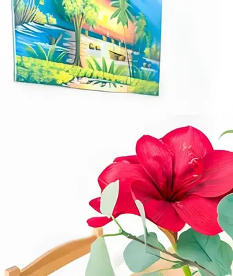 a red flower in a vase on a table at Coral Village II in Punta Cana
