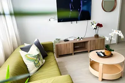 a living room with a green couch and a table at Coral Village II in Punta Cana