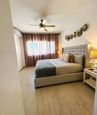 a bedroom with a bed and a ceiling fan at Coral Village II in Punta Cana