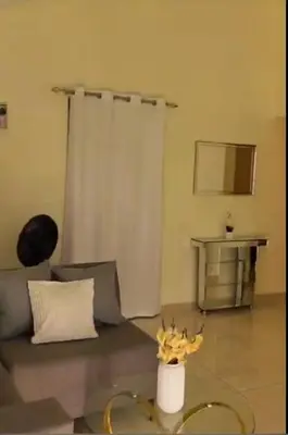 a living room with a couch and a vase of flowers at Kass Luxe in Colorado