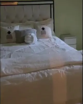 a white bed with towels and pillows on it at Kass Luxe in Colorado