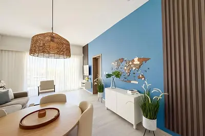 a living room with a table and a blue wall at Alojamientos en Coral Bay II Cerca del Hard Rock Hotel Punta Cana in Punta Cana