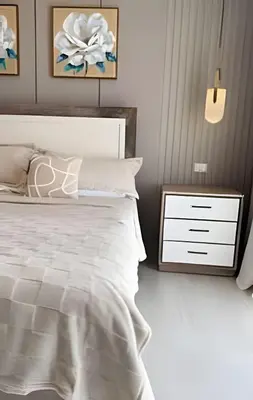 a bedroom with a white bed and a nightstand at Alojamientos en Coral Bay II Cerca del Hard Rock Hotel Punta Cana in Punta Cana