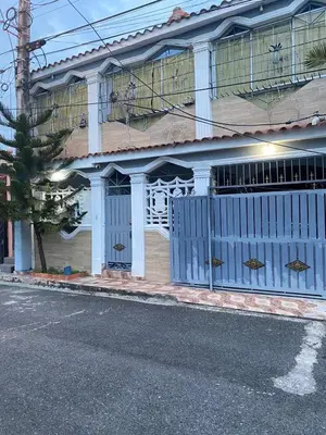 a blue gate on the side of a house at Recidencial sharael house in San Isidro